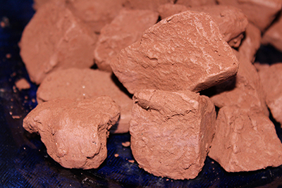 This edible reddish brown clay in mined from a mountain wall.